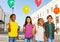 Team of kids with colorful balloons standing