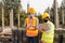 A team of male and female engineers or architects is exploring and inspecting the outdoor construction site work