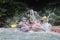 Team of people in raft in the middle of  mountain river.