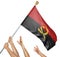 Team of peoples hands raising the Angola national flag