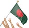 Team of peoples hands raising the Bangladesh national flag