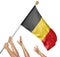 Team of peoples hands raising the Belgium national flag