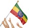 Team of peoples hands raising the Ethiopia national flag