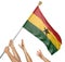 Team of peoples hands raising the Ghana national flag