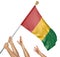 Team of peoples hands raising the Guinea national flag