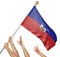 Team of peoples hands raising the Haiti national flag