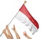 Team of peoples hands raising the Indonesia national flag