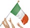 Team of peoples hands raising the Ireland national flag