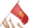 Team of peoples hands raising the Kyrgyzstan national flag