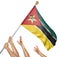 Team of peoples hands raising the Mozambique national flag