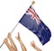 Team of peoples hands raising the New Zealand national flag