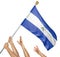 Team of peoples hands raising the Nicaragua national flag