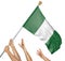 Team of peoples hands raising the Nigeria national flag