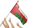 Team of peoples hands raising the Oman national flag
