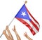 Team of peoples hands raising the Puerto Rico national flag