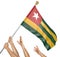 Team of peoples hands raising the Togo national flag