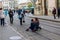A team of photographers takes pictures of a romantic young man and a young woman hugging and kissing on the ancient street of the