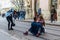 A team of photographers takes pictures of a romantic young man and a young woman hugging and kissing on the ancient street of the