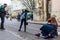 A team of photographers takes pictures of a romantic young man and a young woman hugging and kissing on the ancient street of the