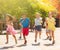 Team of positive kids running in race in the street and laughing