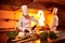 Ð team of professional chefs cook meals with frying pan and fire in the kitchen of restaurant.  Chief chef preparing dish using