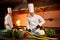 Ð team of professional chefs cook meals with frying pan and fire in the kitchen of restaurant.  Chief chef preparing dish using