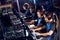 Team of professional cybersport gamers wearing headphones participating in eSport tournament while sitting in gaming
