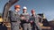 Team of professional male engineering worker in uniform discussing working plan at construction site