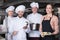 Team of restaurant staff posing together`