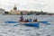 Team of rowers in a boat.