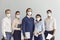 Team of startups in protective masks at work due to the epidemiological situation in the world.