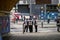 Team of street cleaners stood at zebra crossing outside Waterloo Station