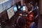 Team of teenage gamers plays in a multiplayer video game on pc in a gaming club.