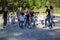 Team of teenagers playing yard football with a children team at sunny day