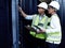 The team to call for your connectivity concerns. two technicians working together in a server room.