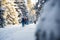 Team tourists hiking with backpacks rises snow-covered slopes on