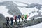 Team of travelers hiking in mountains.