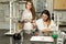 Team of two female laboratory technicians working in chemical or pharmaceutical laboratory