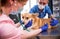 A team of veterinarians examines a sick Corgi dog using an stethoscope