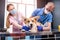 A team of veterinarians examines a sick Corgi dog using an stethoscope