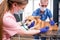 A team of veterinarians examines a sick Corgi dog using an stethoscope