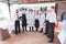 A team of waiters conduct a briefing on the summer terrace of the restaurant