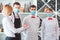 A team of waiters conduct a briefing on the summer terrace of the restaurant