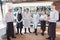 A team of waiters conduct a briefing on the summer terrace of the restaurant