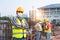 Team work of Construction engineers technician and  architect supervising progress stand in control of building foundations