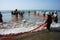 Team work of fisherman on beach