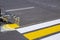 A team of workers drawing a pedestrian crossing in early spring using automated equipment on fresh asphalt