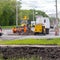 A team of workers with the help of special equipment break open the asphalt on the carriageway on the street