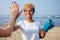 Team workout concept. happy african american woman giving highfive hand clap to her friend on beach summer sea