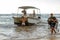 team of young divers boys and girls carry equipment from the boat after the dive